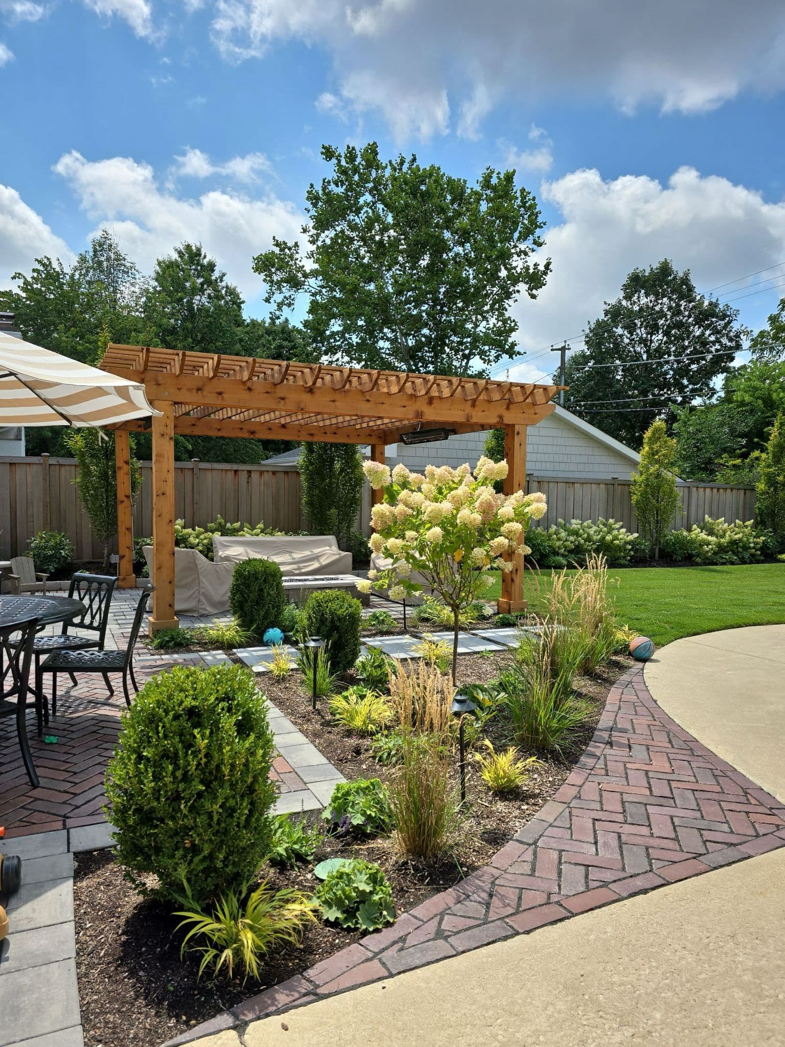 Completed outdoor design project by Leguizamos & Sons — pergola, pavers and landscaping